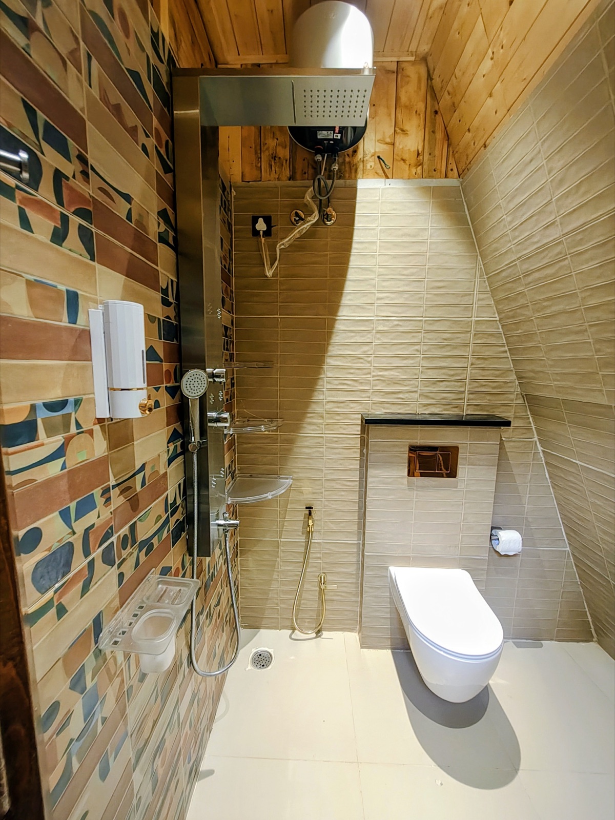 En-suite bathroom with a rain shower and stone-mosaic feature wall