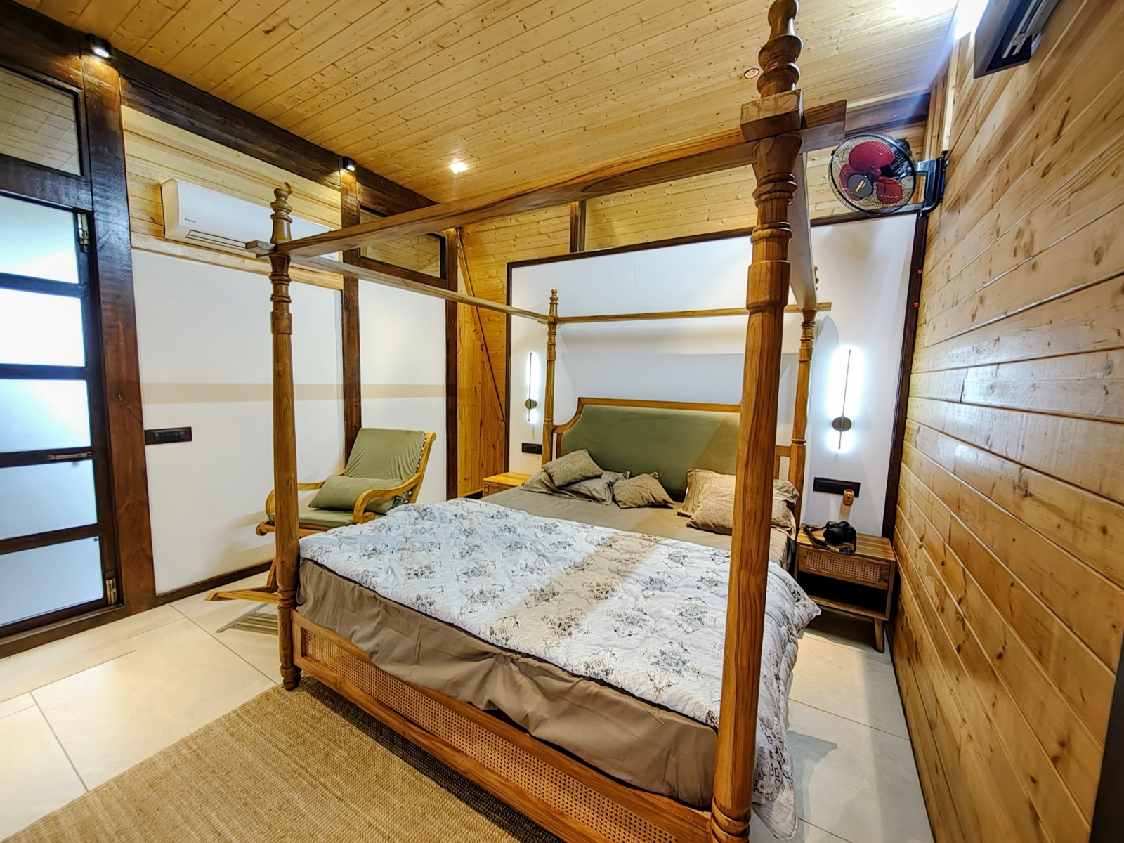 Warm wooden bedroom with a carved four-poster bed