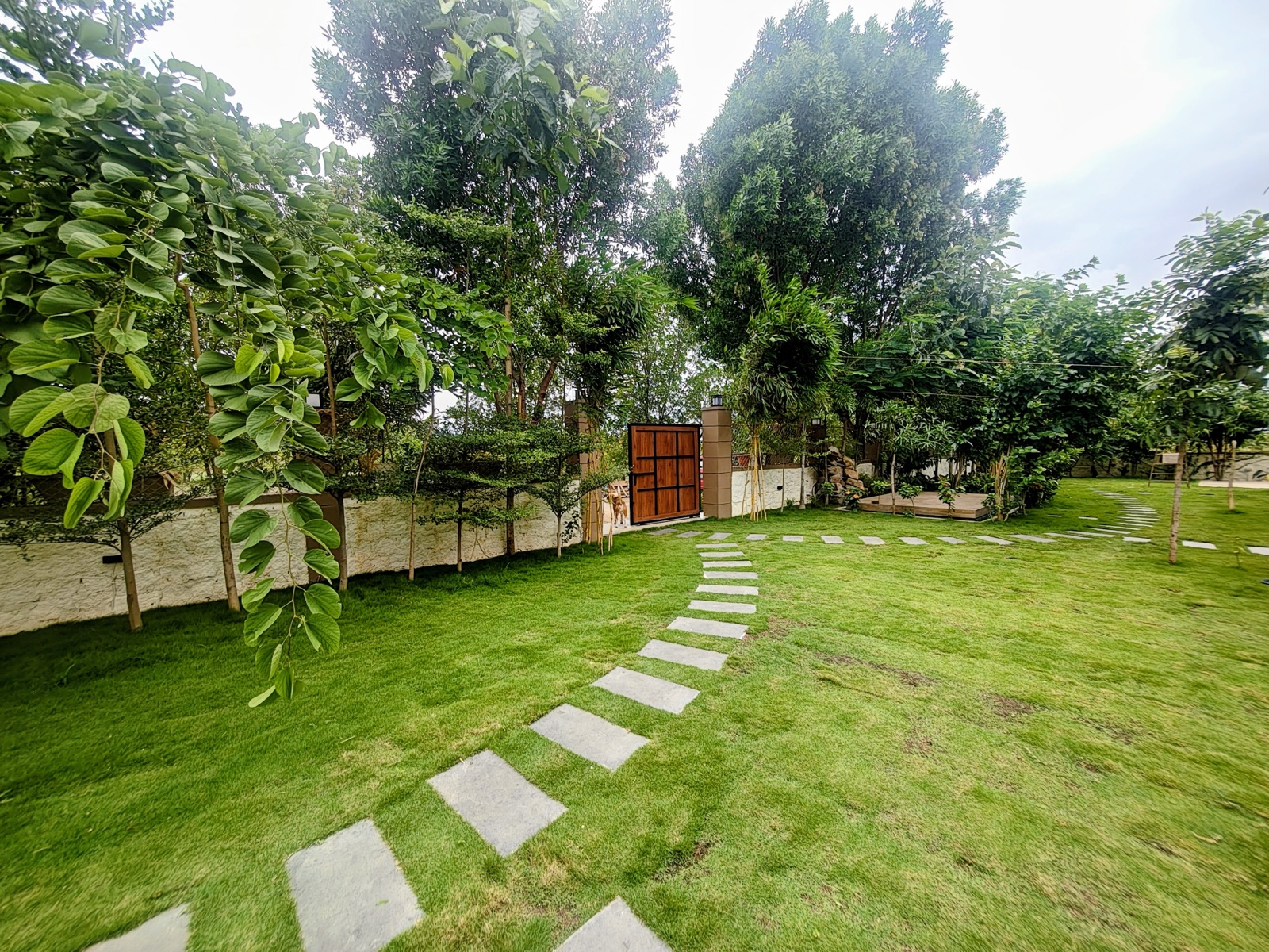 Stepping-stone path winding across the manicured garden lawn