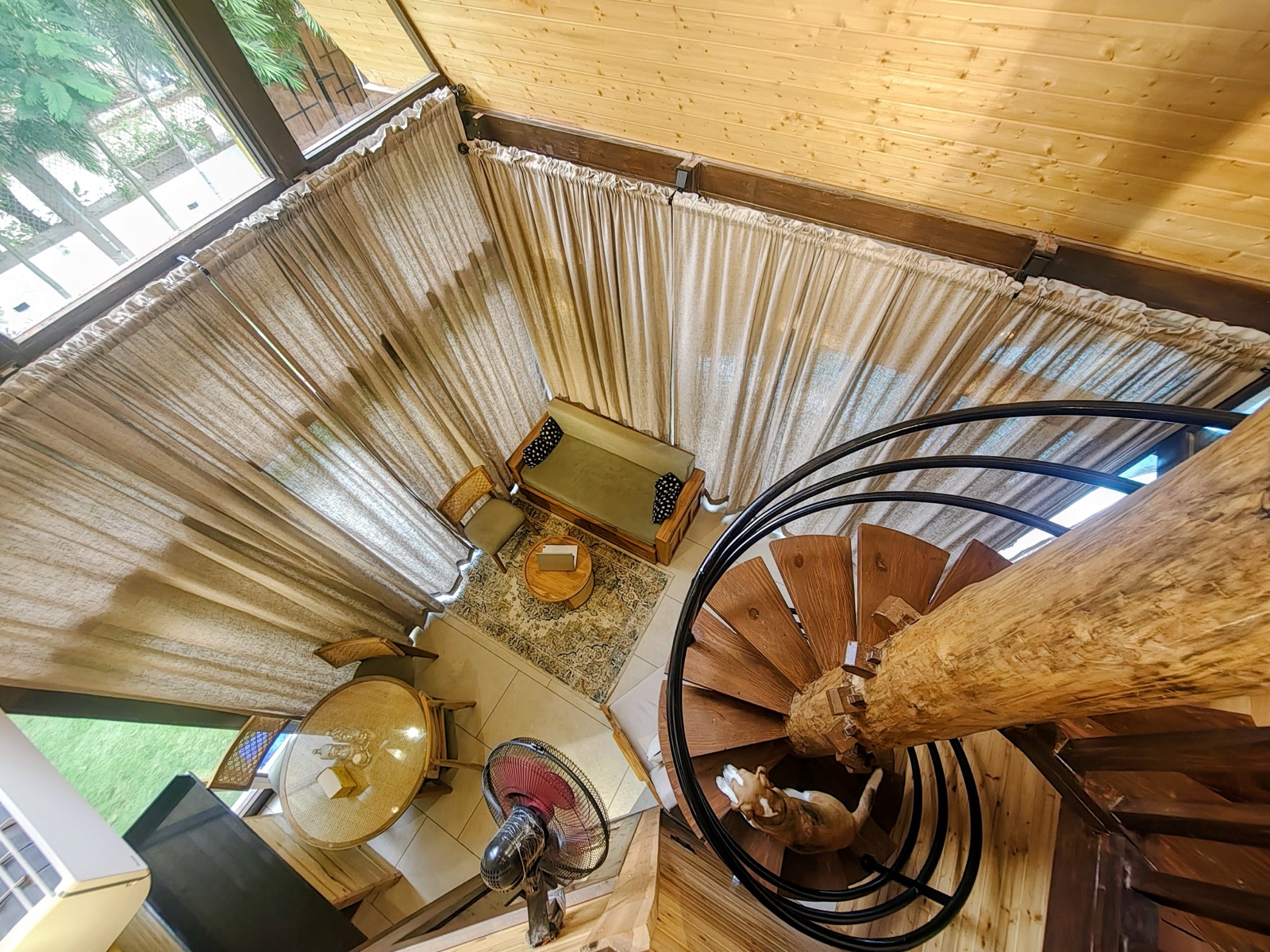 Wooden spiral staircase leading up to the cabin loft